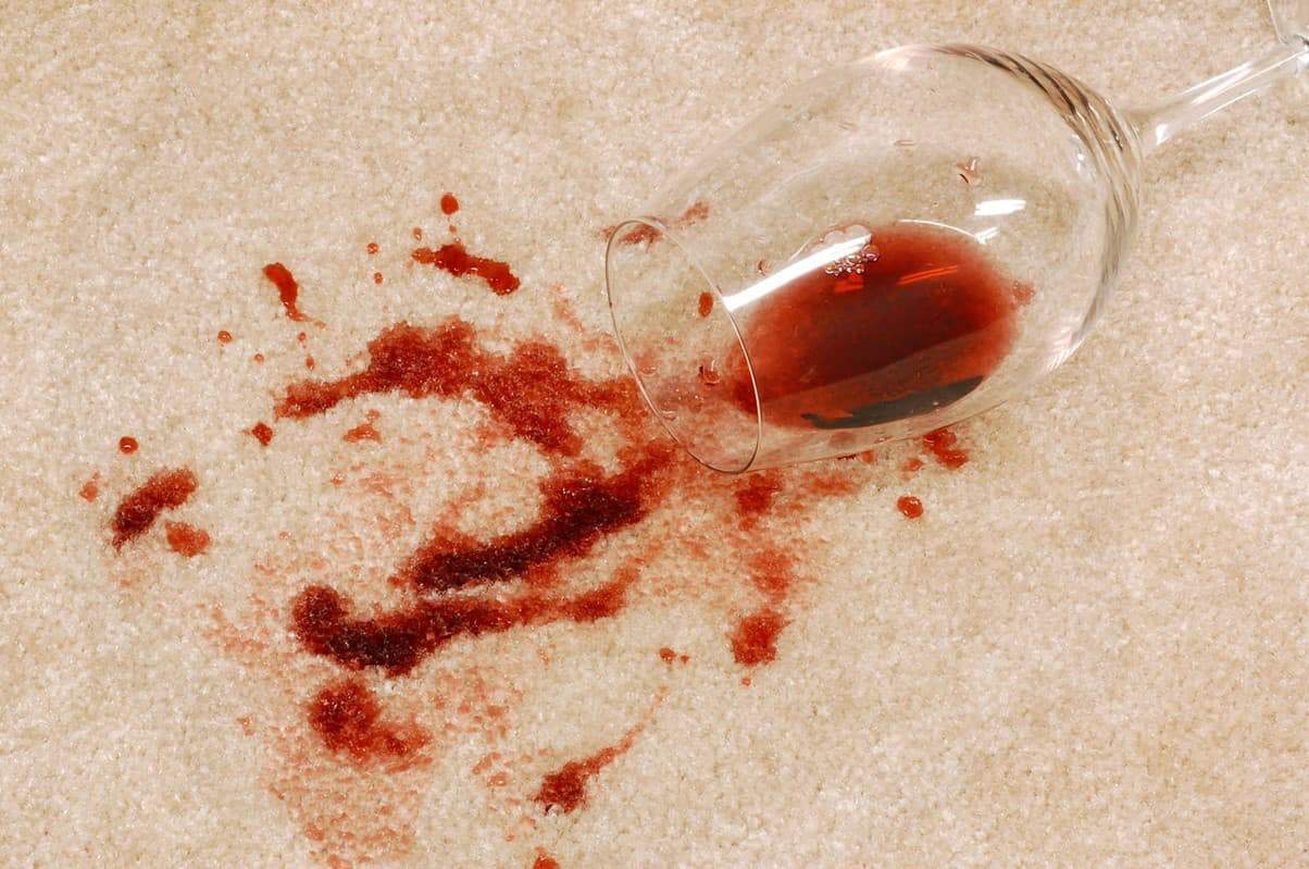 Red wine stain on a white carpet